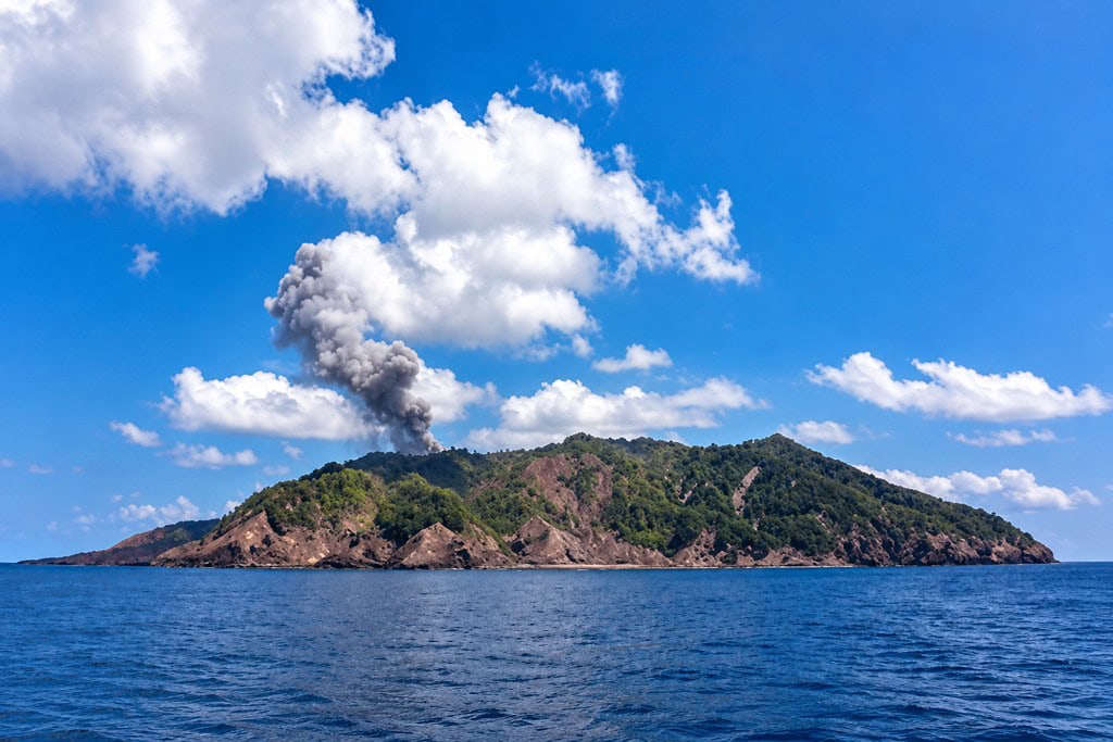 Rugged volcanic terrain of Barren Island surrounded by the Andaman Sea