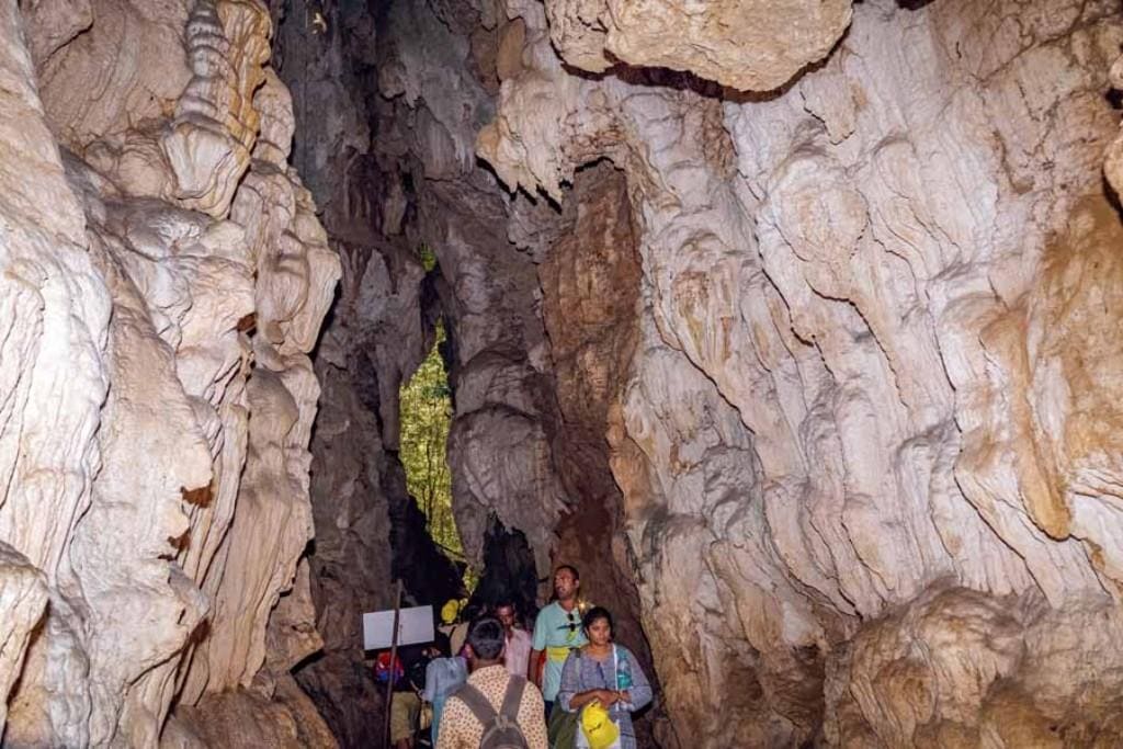 Tourists exploring the limestone cave in Baratang Island, Andaman.