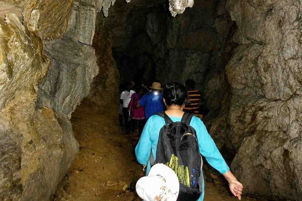 Tourists exploring the limestone cave in Baratang Island, Andaman.