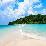 Quiet sandy shoreline at Ross and Smith Islands near Diglipur surrounded by tropical greenery
