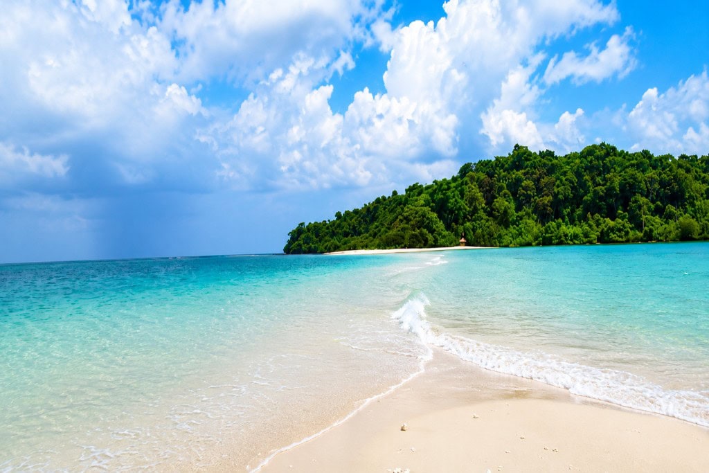 Quiet sandy shoreline at Ross and Smith Islands near Diglipur surrounded by tropical greenery