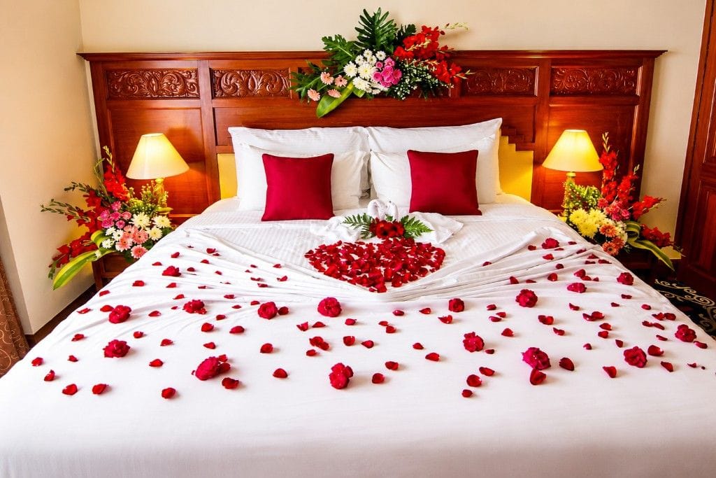 Flower bed decoration for an Andaman honeymoon hotel room with romantic floral arrangements and elegant setup.