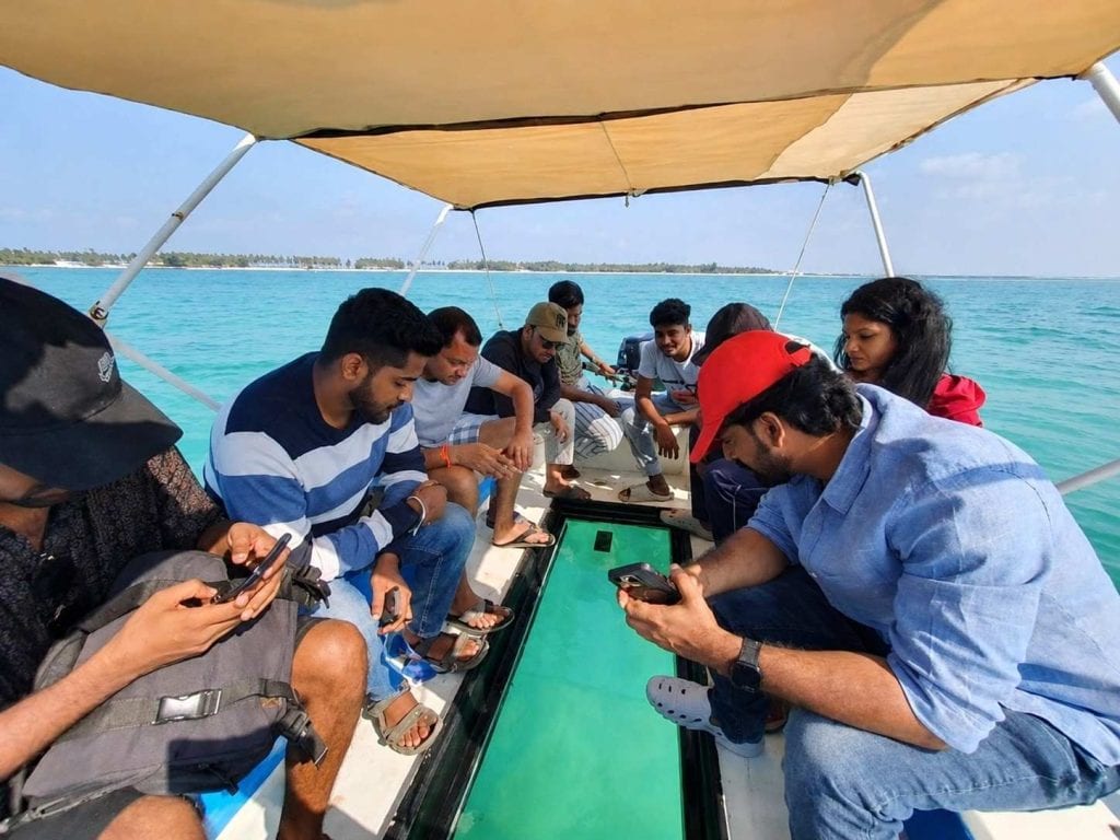 Glass Bottom Boat Ride in Andaman for viewing colorful coral reefs and marine life through clear underwater panels.