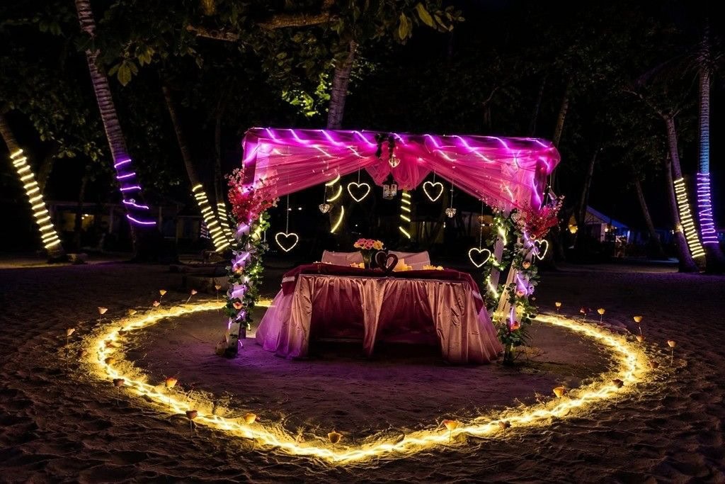 Couple enjoying private candle light dinner by the beach in Andaman