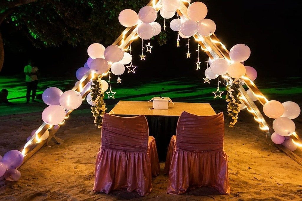 Couple enjoying sunset candle light dinner on an Andaman beach