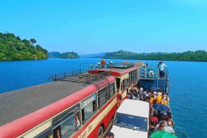 Boat ride on calm waters with tourists enjoying the scenic view.