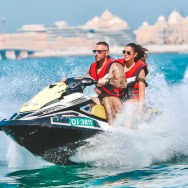 Couple enjoying jet ski ride in clear blue waters of Andaman.
