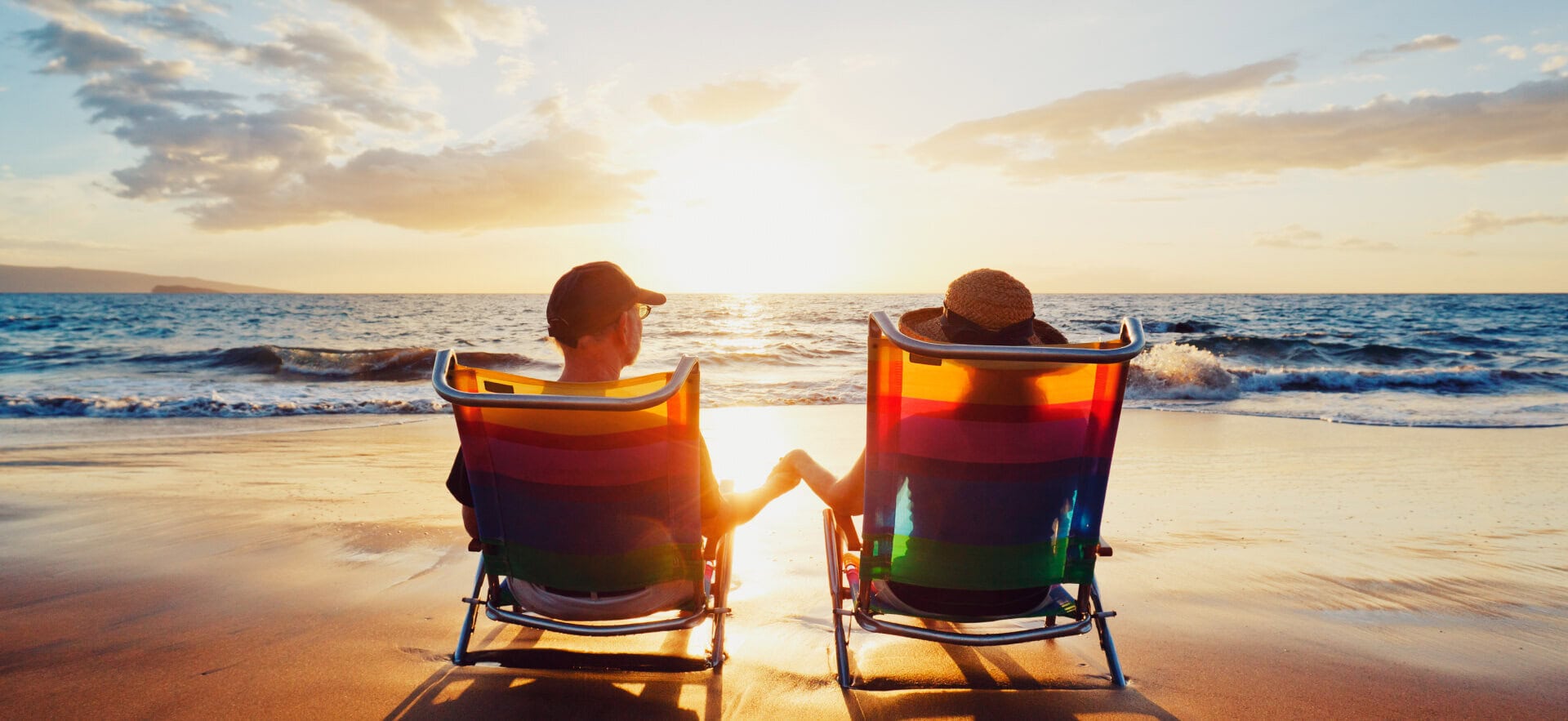 Couple relaxing on beach chairs during sunset in Andaman Islands.