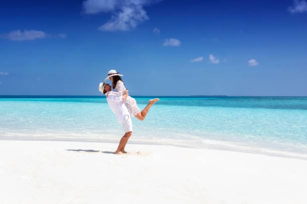 Romantic honeymoon couple enjoying a beautiful beach vacation in the Andaman Islands with the best Andaman Honeymoon Tour Packages featuring luxury stays, ferry rides, sightseeing, and unforgettable experiences.