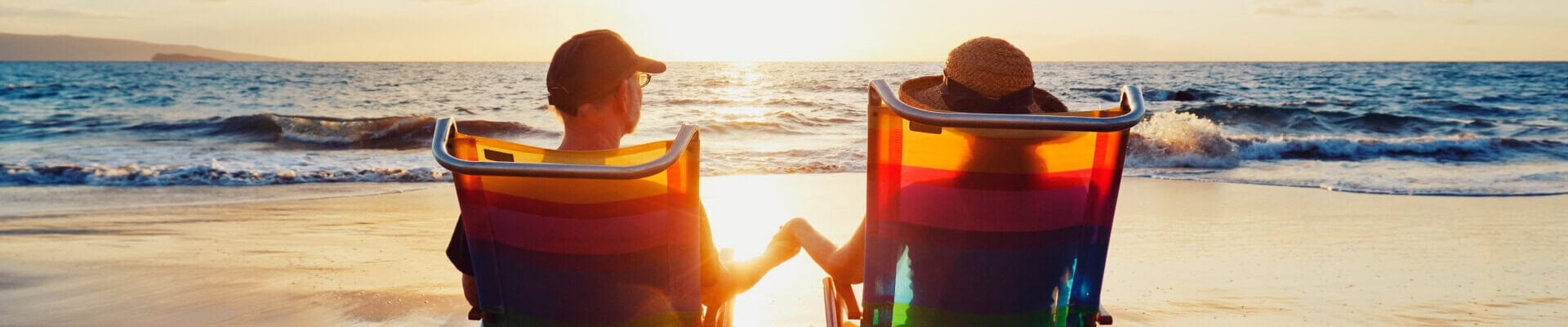 Couple relaxing on beach chairs during sunset in Andaman Islands.