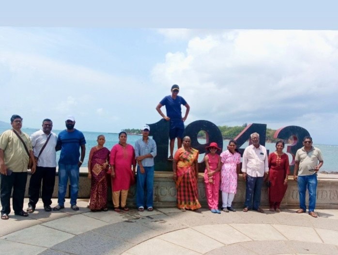 Happy family group posing after completing their Andaman tour with Andaman Ocean Tours & Travels at a beautiful tourist destination in the Andaman Islands.