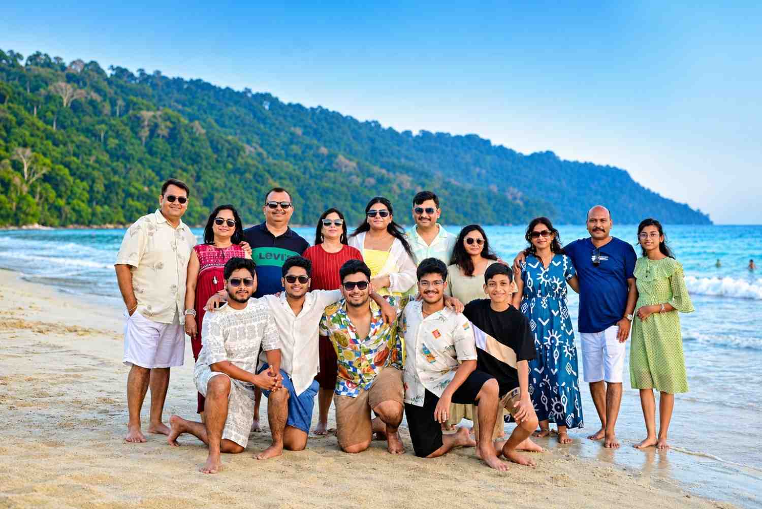 Happy group family from Tamil Nadu enjoying Radhanagar Beach on Havelock Island during their Andaman family tour with Andaman Ocean Tours & Travels.
