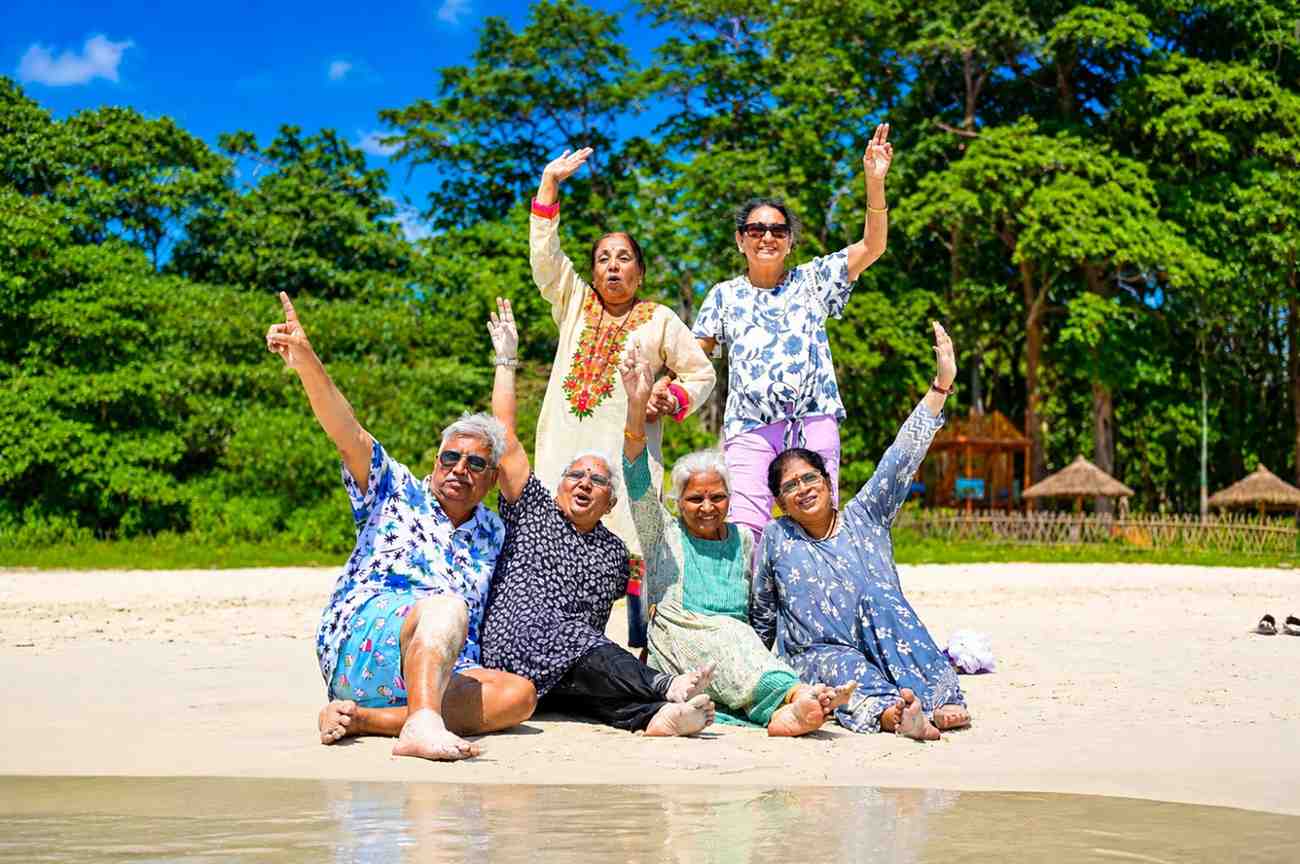 Happy senior citizen group from Bangalore enjoying a memorable beach holiday in the Andaman Islands with Andaman Ocean Tours & Travels.