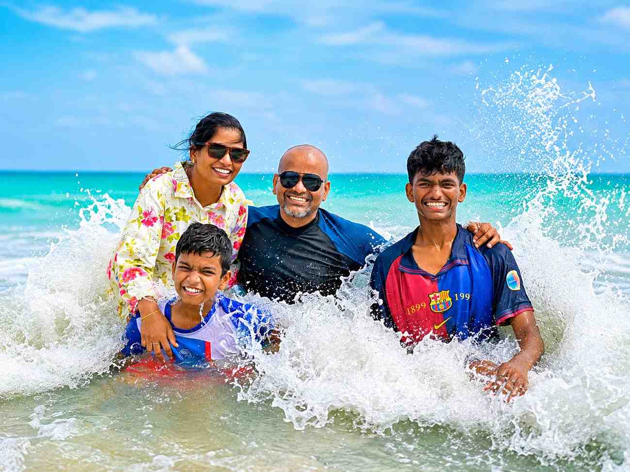 Happy family from Tamil Nadu enjoying the sea waves at Havelock Island during their Andaman family tour with Andaman Ocean Tours & Travels.