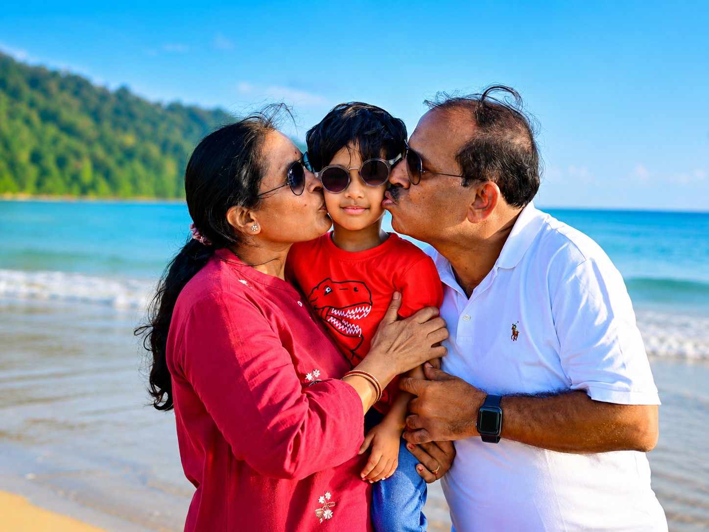 Happy parents sharing a beautiful moment with their child at Havelock Island during their Andaman family vacation from Chennai with Andaman Ocean Tours & Travels.