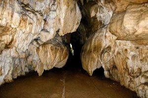 Cave entrance in Andaman with rugged rocks and narrow passage.