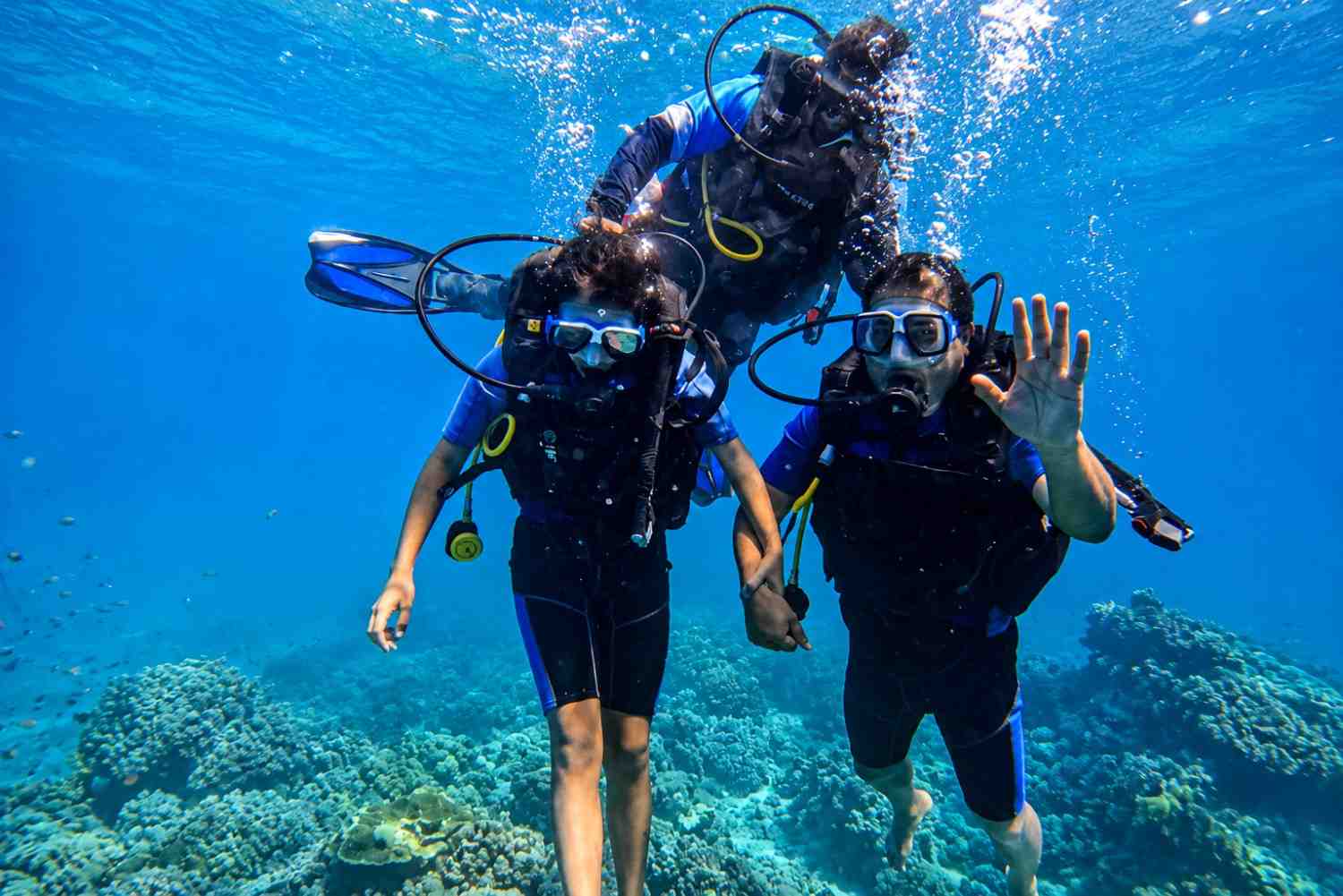 Guests enjoying scuba diving in the Andaman Islands during their Andaman tour package from Bangalore.
